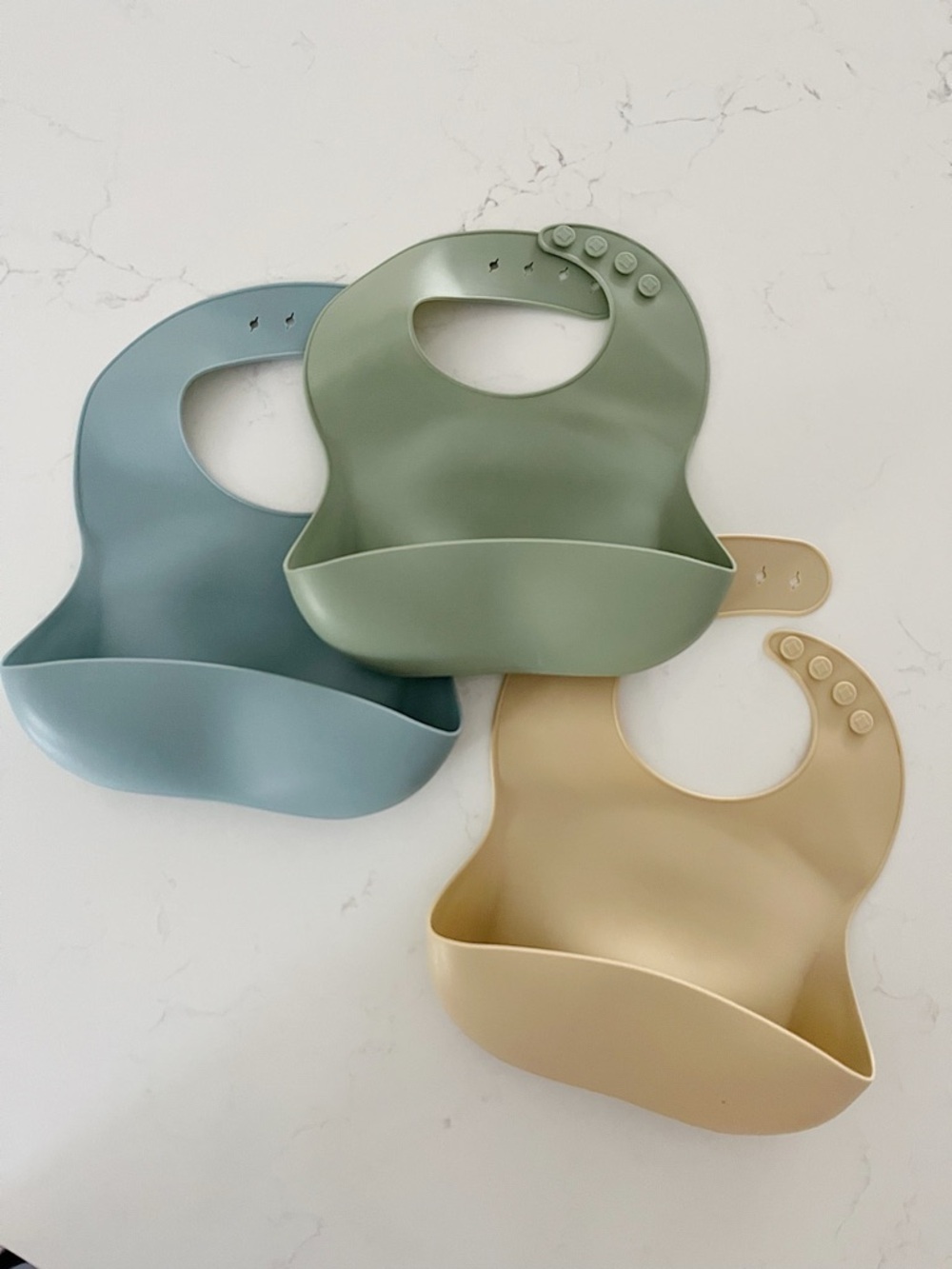 • set of three silicone bibs •